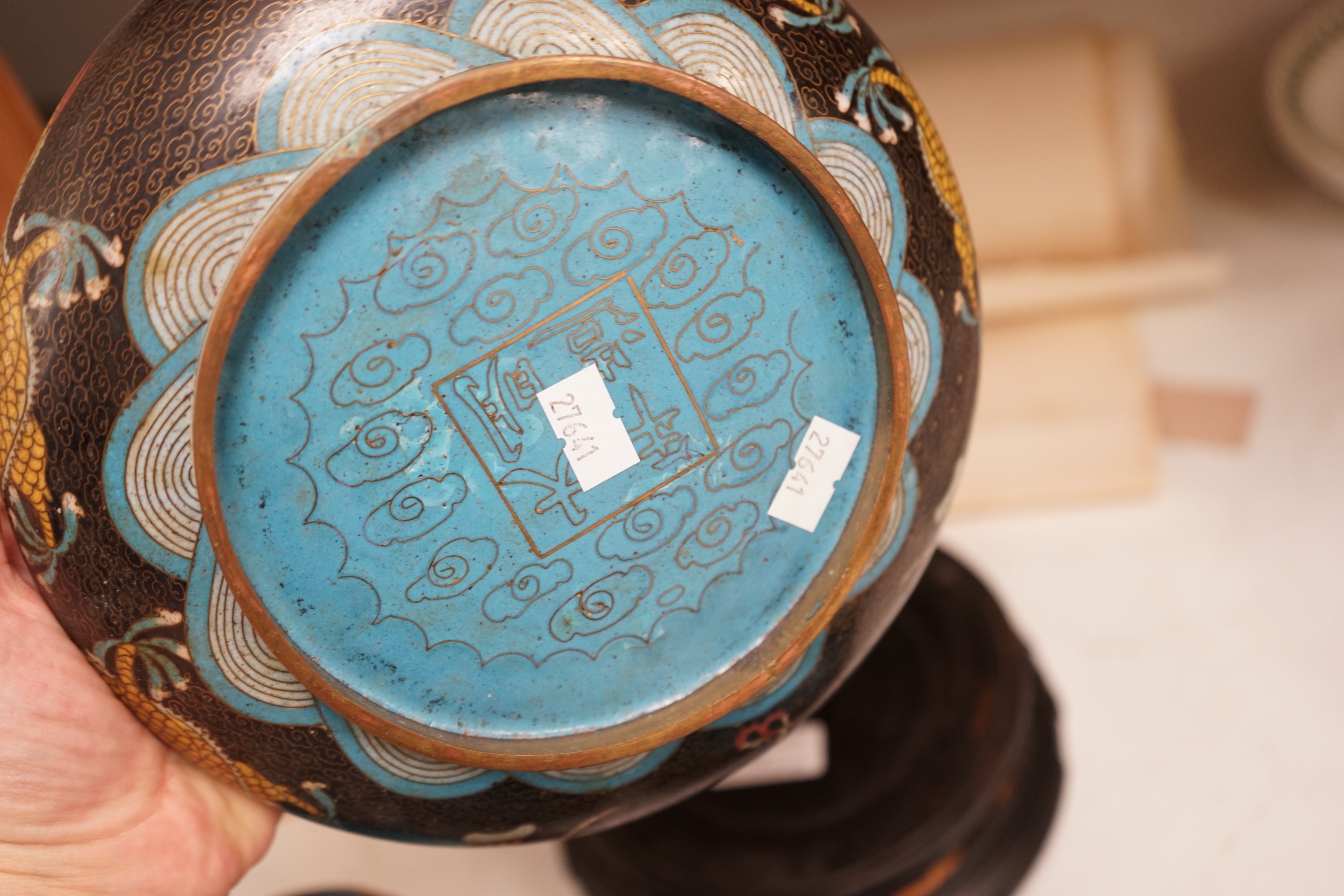 A Chinese cloisonné enamel 'dragon' bowl, six Chinese floral cloisonné enamel bowls and four Canton enamel dishes and wood stands